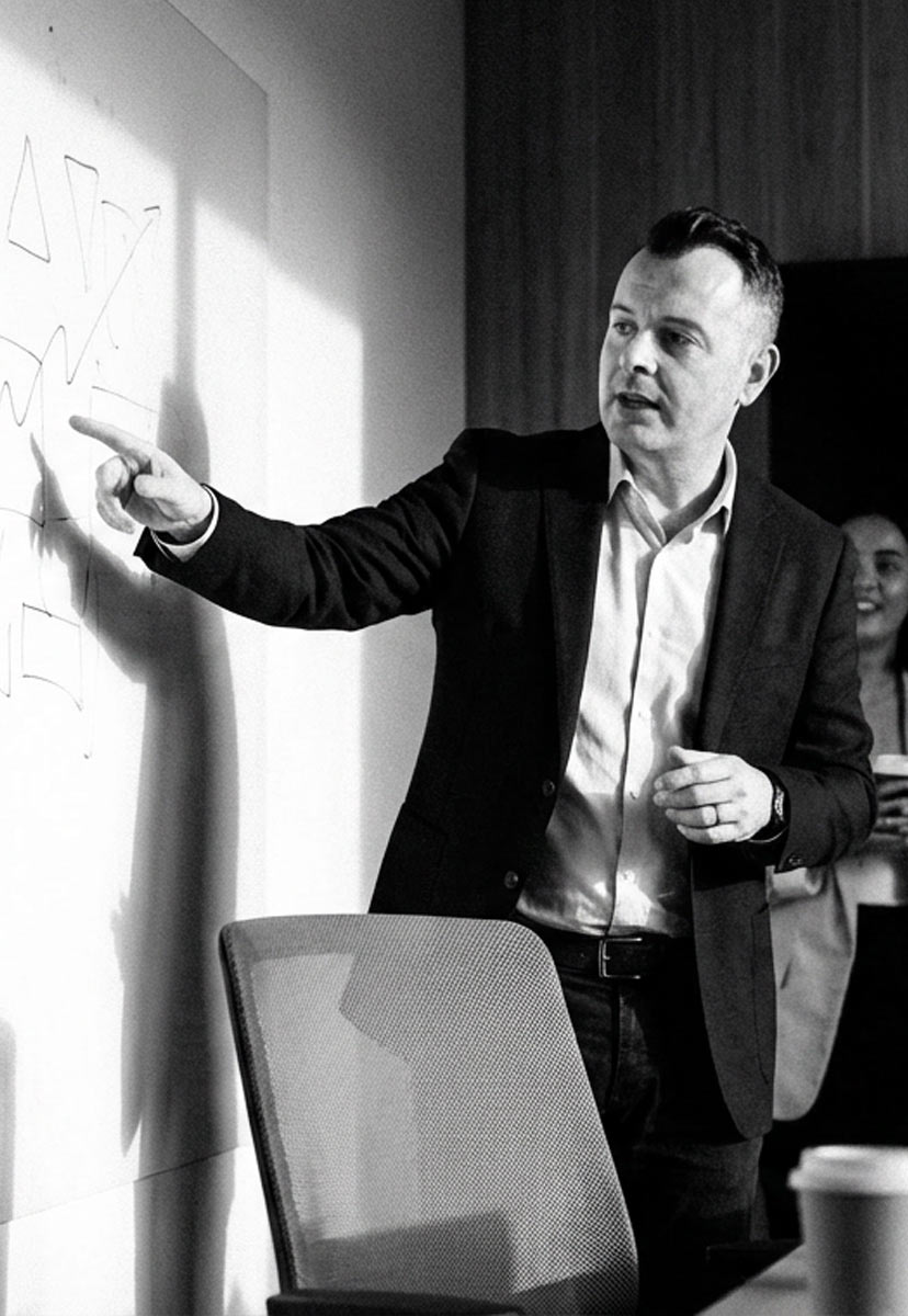 Efren Cavazos leading a positioning workshop at a whiteboard